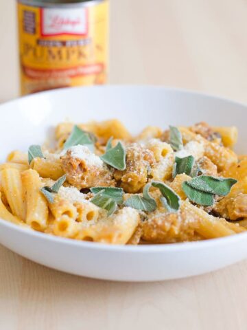 Rigatoni with spicy pumpkin sausage sauce in a round white pasta bowl.