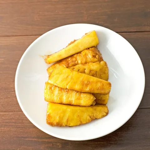 grilled pineapple on a white round plate