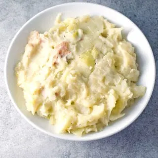 Prepared colcannon in a white round bowl.