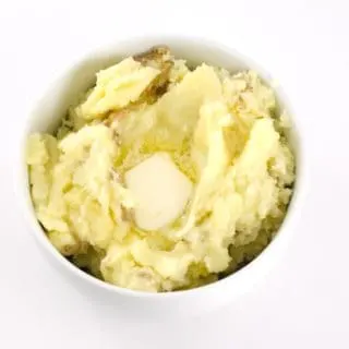 Skin-On mashed potatoes in a white round bowl.