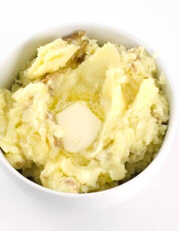 Skin-On mashed potatoes in a white round bowl.