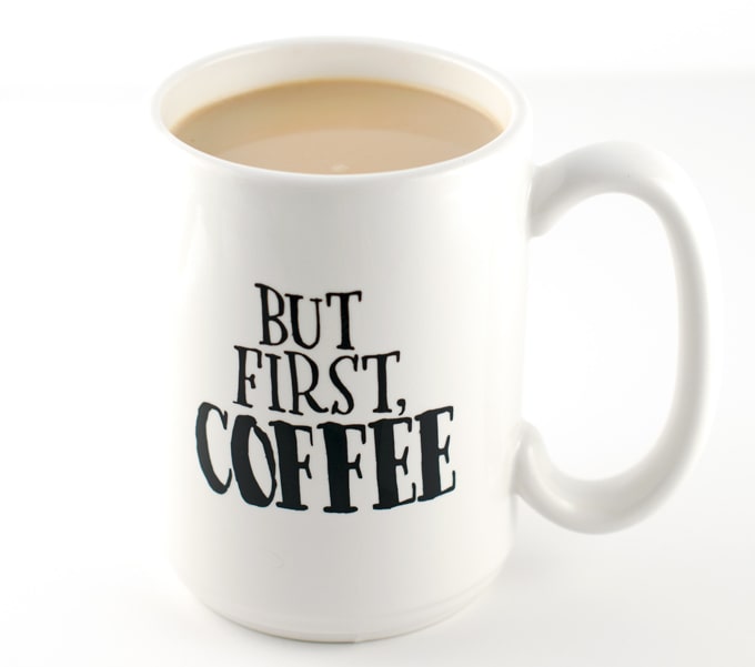 white coffee mug with words but first, coffee in black letters filled with coffee