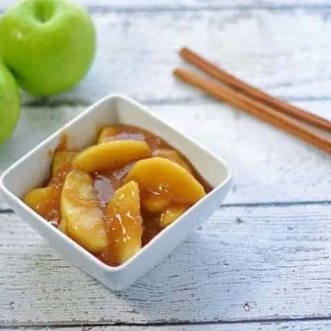 Southern fried apples in a white square bowl.