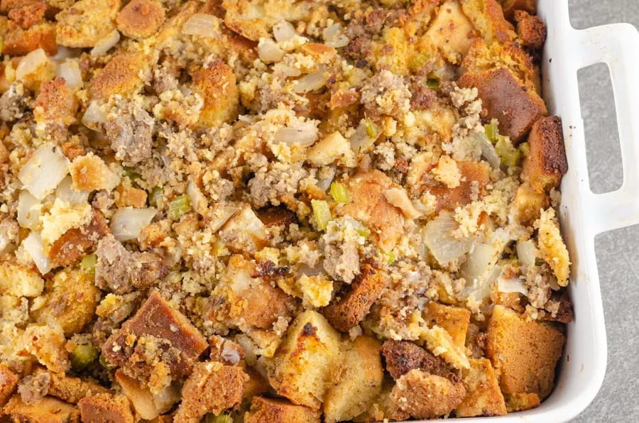 Sausage Cornbread Dressing Recipe close-up photo after being baked in a white casserole dish