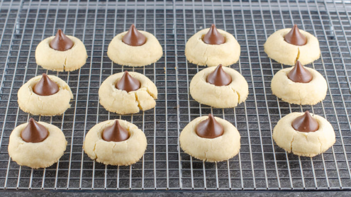 https://smartsavvyliving.com/wp-content/uploads/2019/12/Shortbread-Hershey-Kiss-Cookies-Recipe-picture-just-baked-cookies-with-kiss-on-rack-2-720x405.jpg