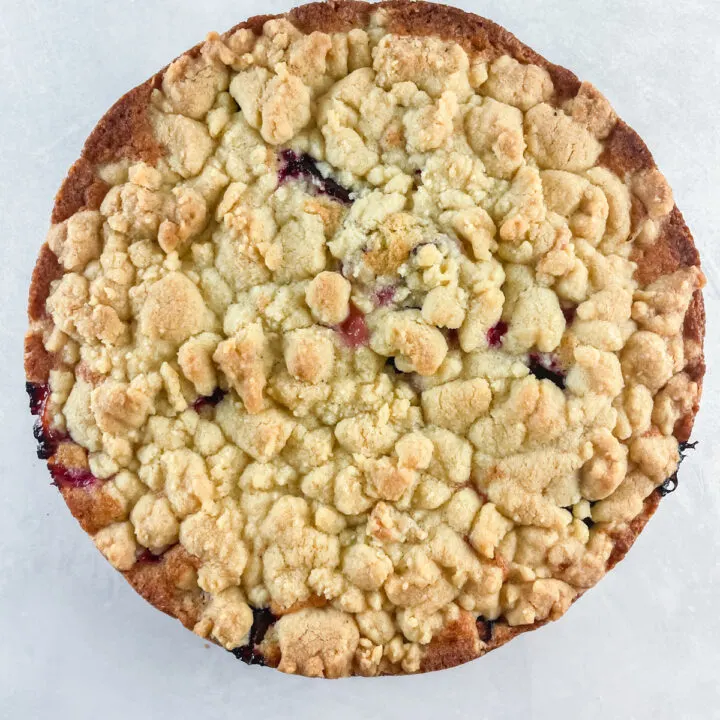 whole round german plum cake on a concrete background