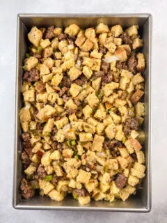 baked sausage and sourdough stuffing in a metal 9 by 13 pan ready to be served