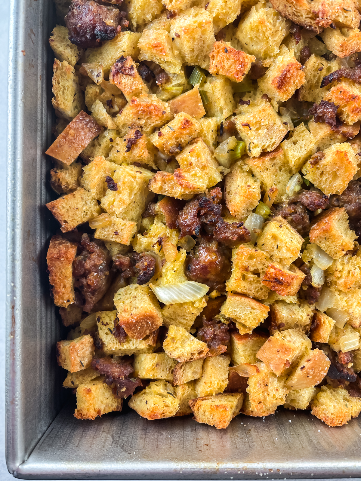 bottom left corner of a pan of sausage and sourdough stuffing