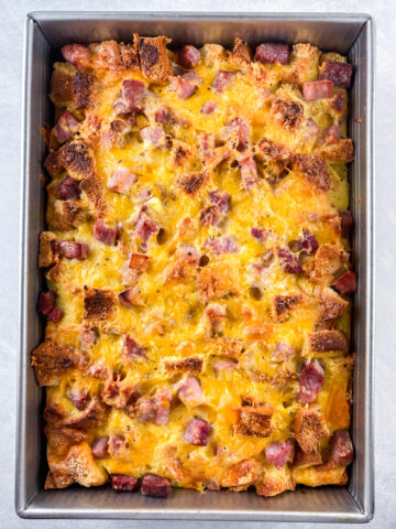 Overhead shot of the ham and egg brioche casserole baked in a 9 x 13 metal pan.