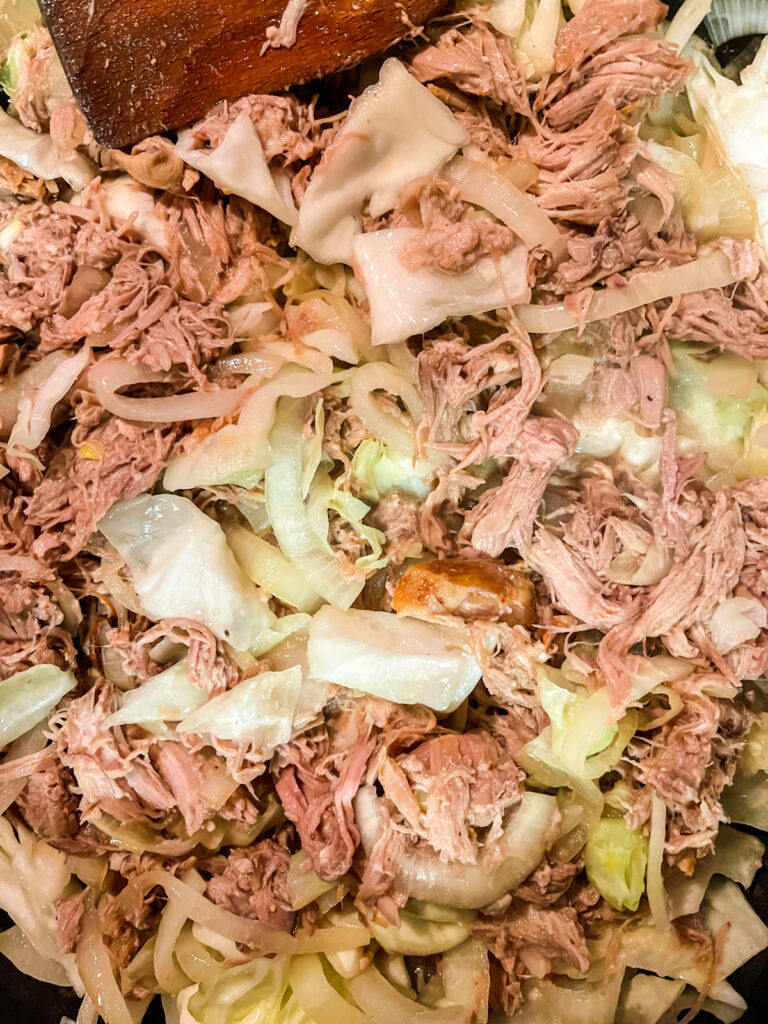 Cooking kalua pork, onions, and cabbage together.