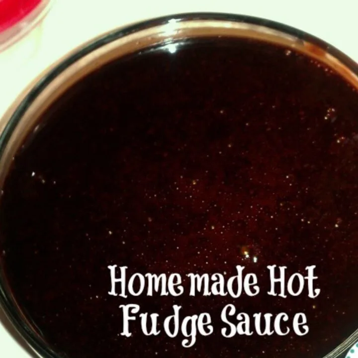 A round glass bowl full of homemade hot fudge sauce