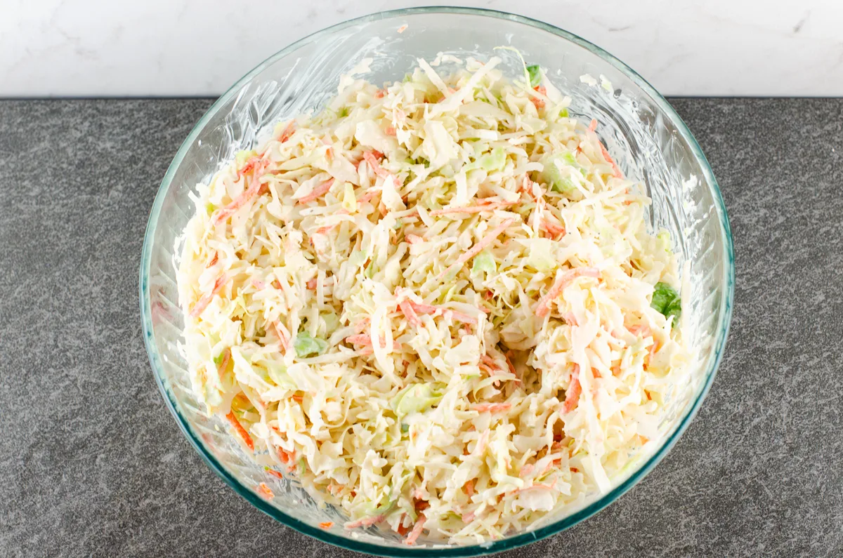 Prepared southern hot dog slaw recipe in a large glass mixing bowl