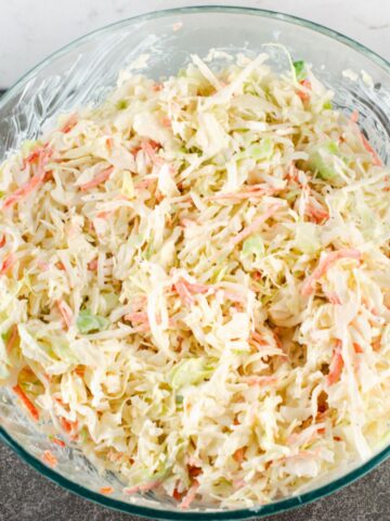 Prepared southern hot dog slaw recipe in a large glass mixing bowl