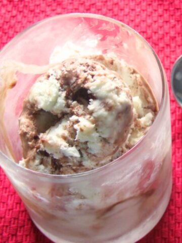 Prepared vanilla fudge swirl ice cream in a stemless glass that has been in the freezer