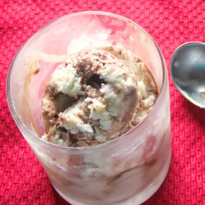 Prepared vanilla fudge swirl ice cream in a stemless glass that has been in the freezer