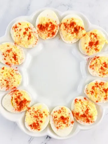 Classic Southern deviled eggs dusted with paprika in a deviled egg tray