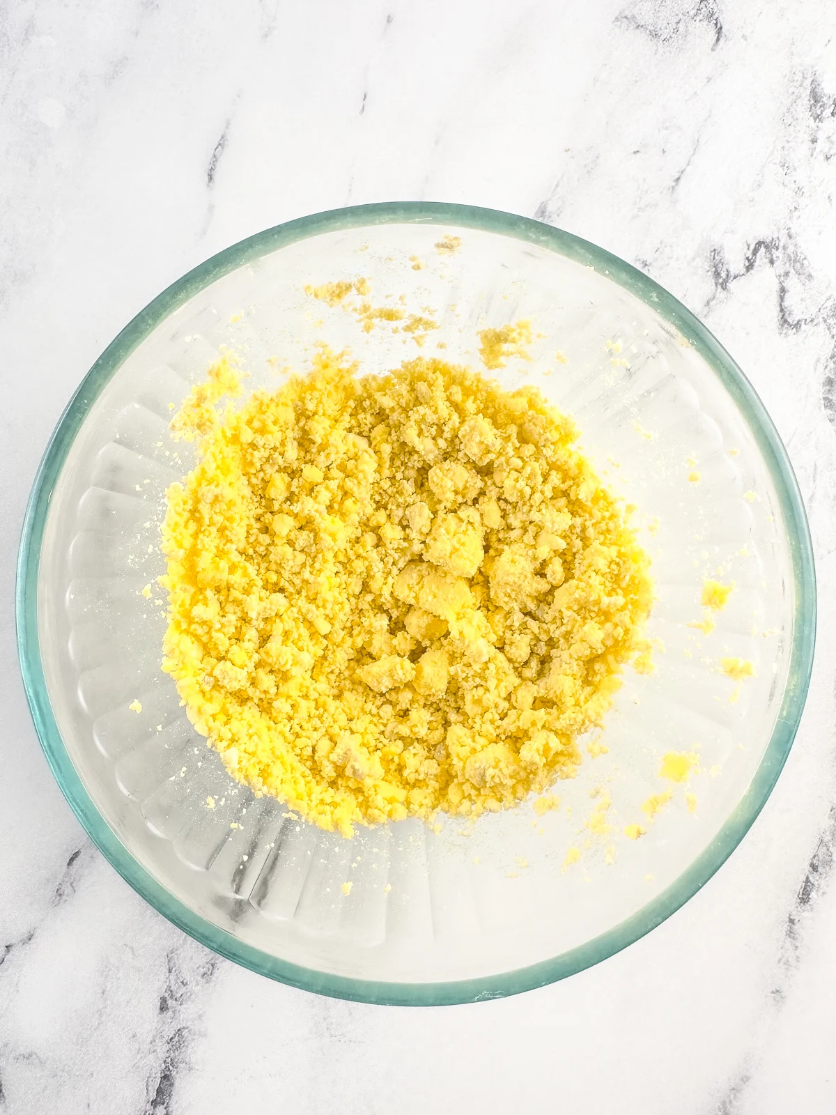 Mashed hard boiled egg yolks in a glass bowl.