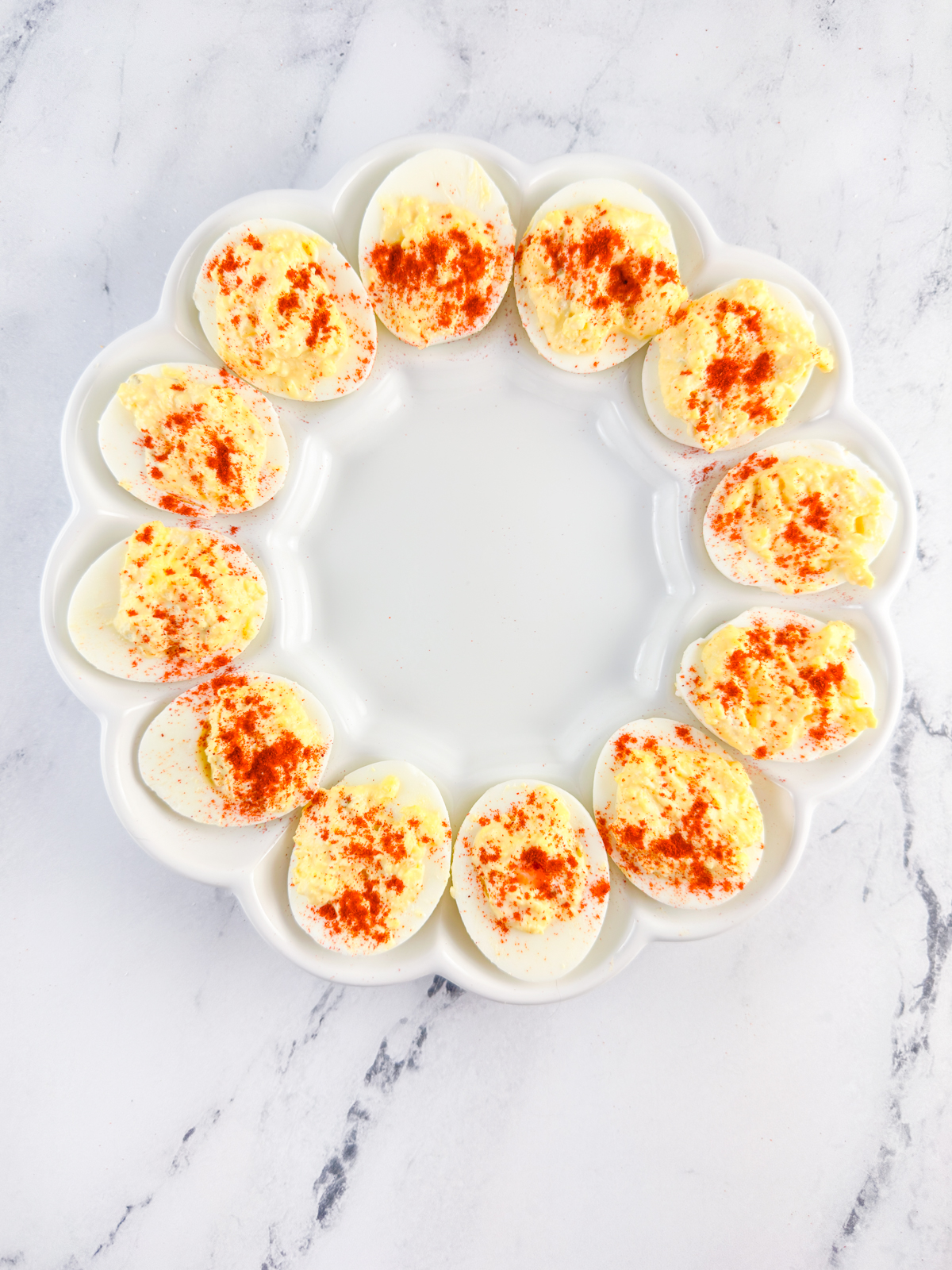 Classic Southern deviled eggs sprinkled with paprika on a serving tray