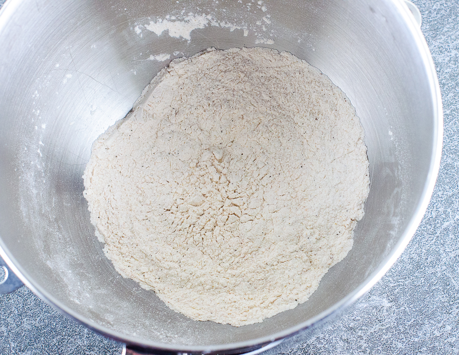 Flour mixed with spices in a stand mixer bowl.