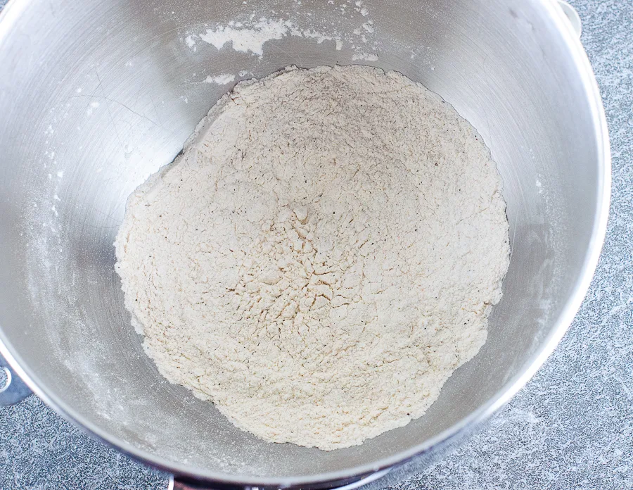 Flour mixed with spices in a stand mixer bowl.
