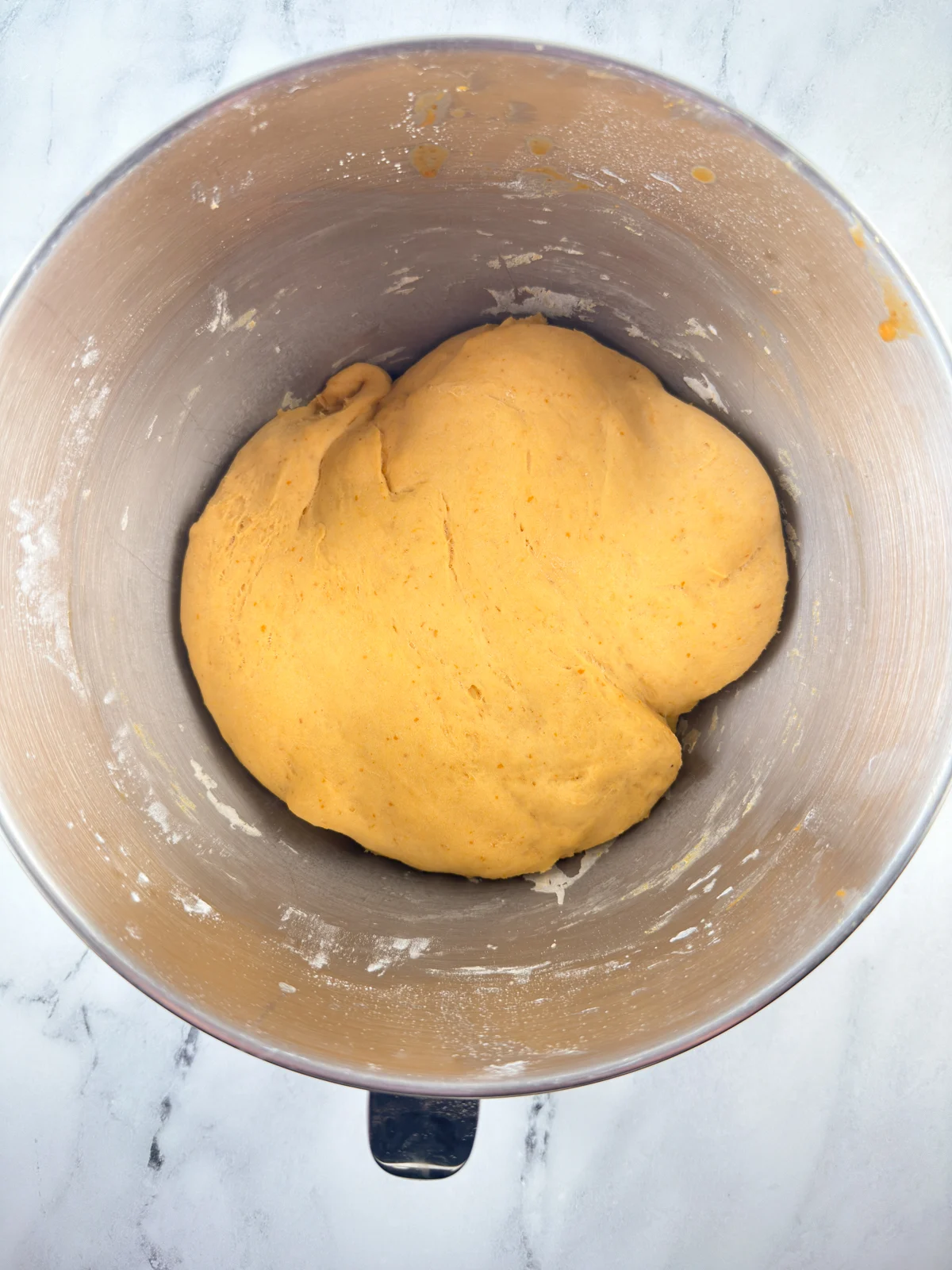 Dough in stand mixer bowl after it has risen.