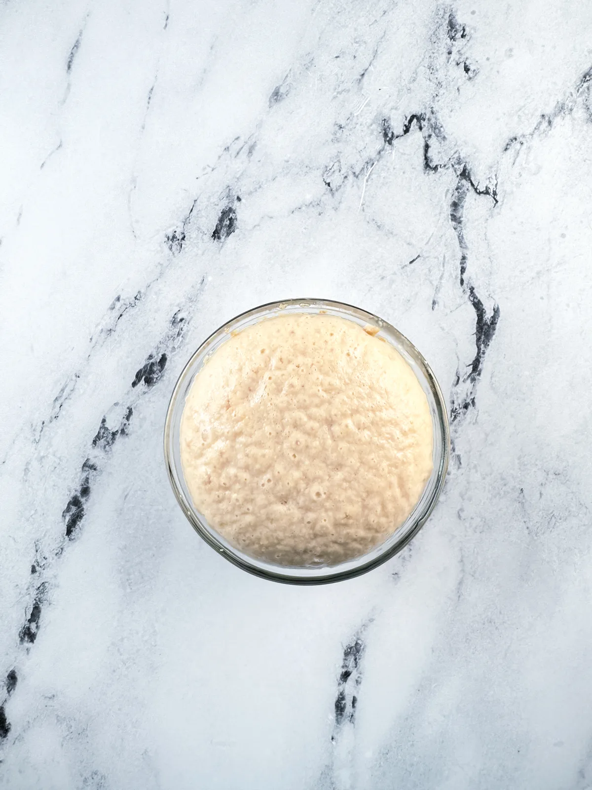 Yeast that has proofed in a small glass bowl.